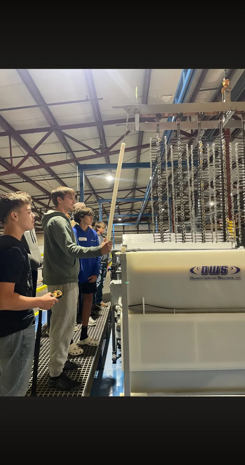 Students watching a demonstration at the anodizing tanks during a plant tour at AnoPRO