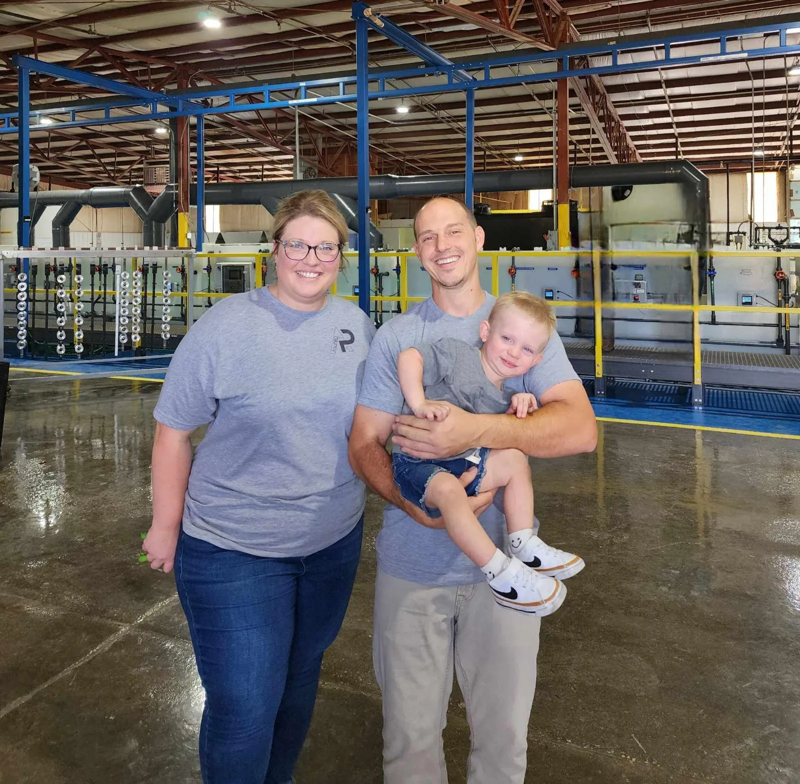 Matthew and Kendall Knight with their son on the AnoPRO plant floor in Paoli