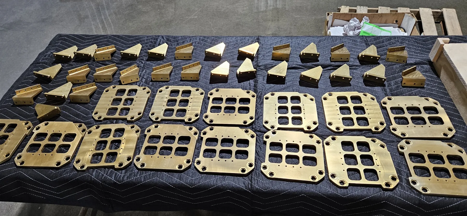 Gold chem film coated aluminum plates laid out after processing at AnoPRO